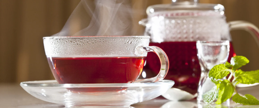 Herbal tea cup, on a table, with warm vapours